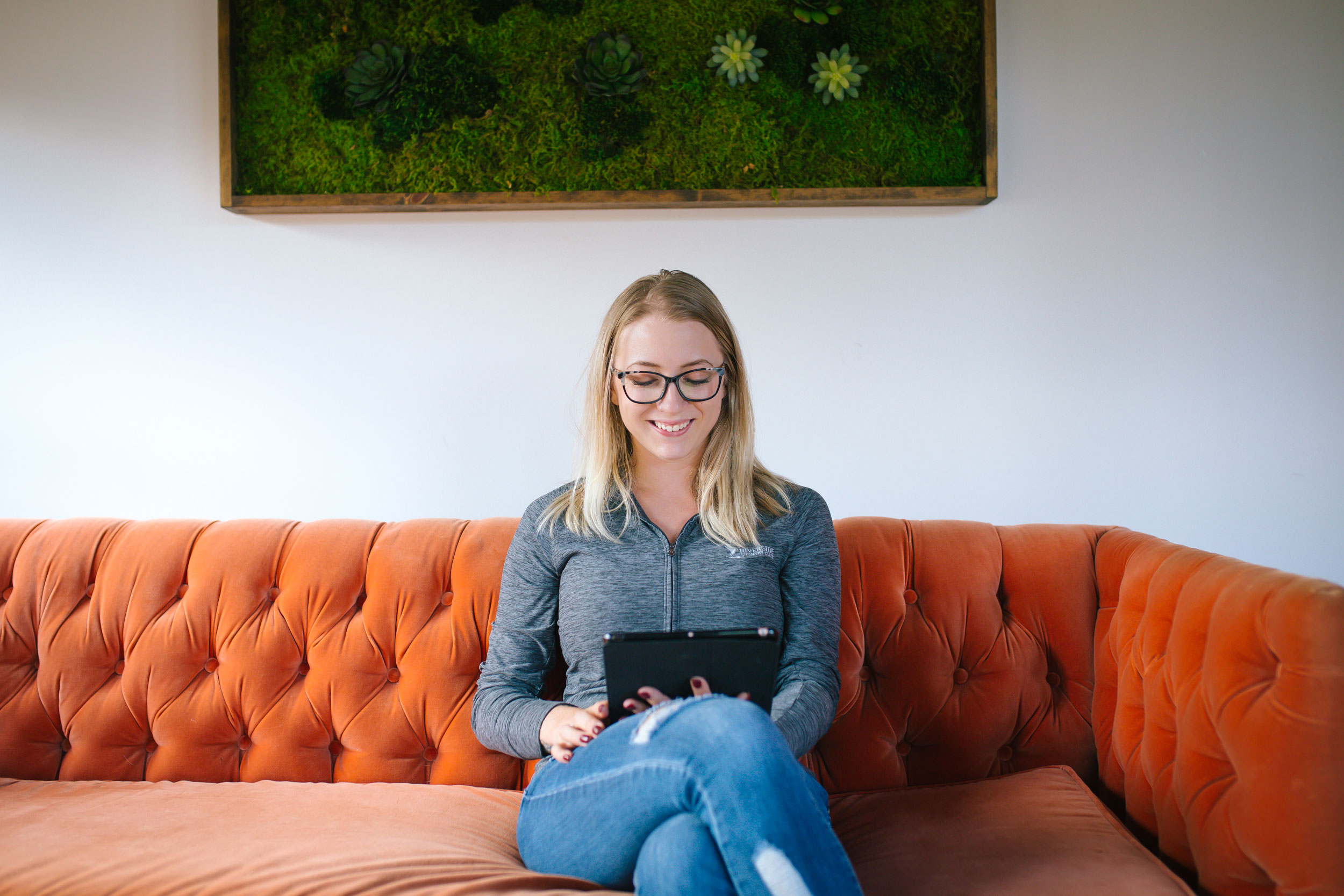 woman sitting on couch with ipad