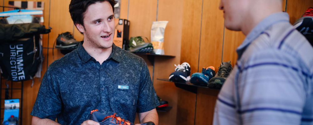 retail worker talking to customer in shop