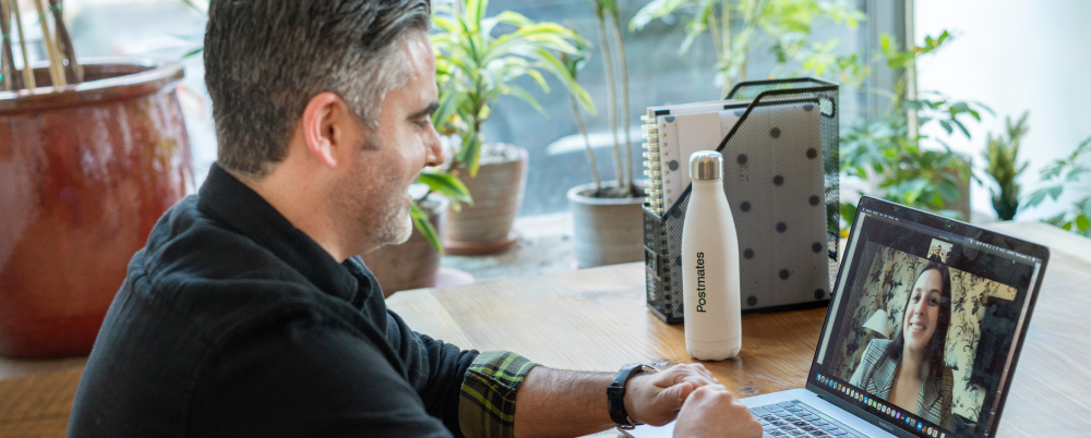 Man using a video chat feature on a laptop to communicate with teammate.
